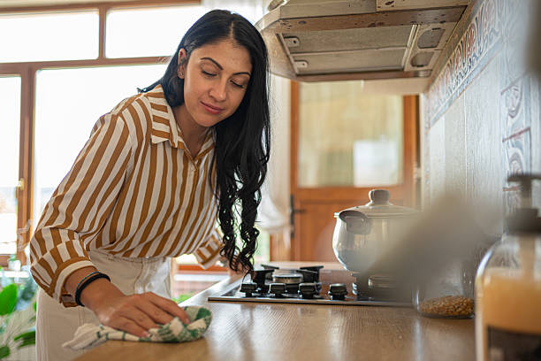 istock Domestic Life. Young Woman Wiping Down Kitchen Counter 2248127736