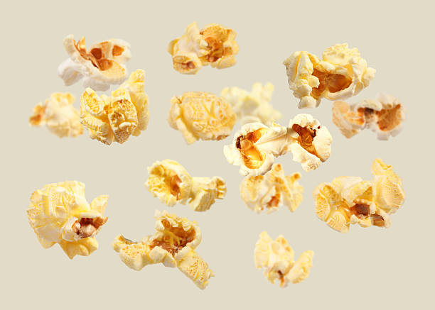 istock Tasty fresh popcorn flying on light grey background 2248136567