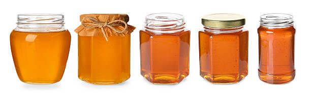 istock Natural honey in glass jars isolated on white, set 2248136656