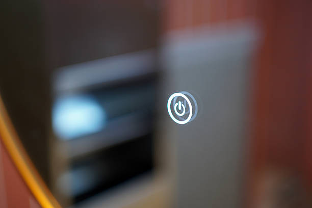 A close-up view of a power button icon in a contemporary indoor environment, highlighting the electronic control element.