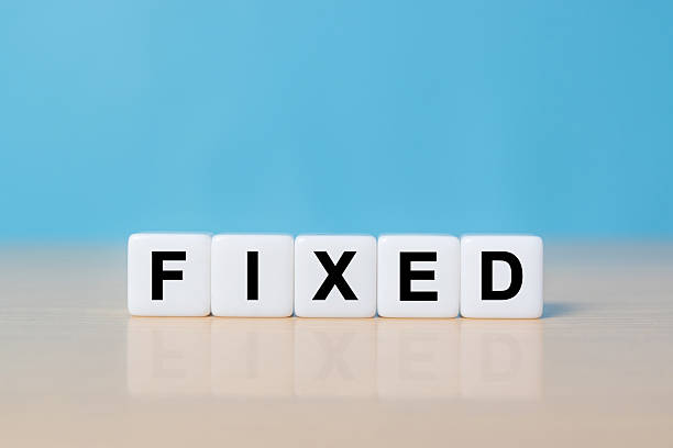 istock Fixed - word from dice with letters, fixed interest rates or costs concept, random letters around 2248140991