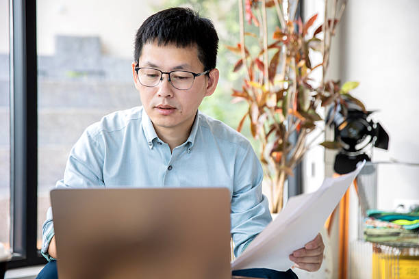 istock An Asian manager is reviewing financial statements on his computer. 2248142104