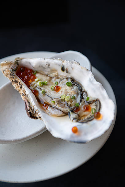 istock Gourmet Oyster with Red Caviar on a White Plate 2248142386