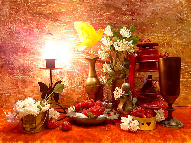 istock Elegant table setting, berries, flowers, dishes. Evening romantic still life on a red background, candle in a candlestick. Romance, flowers, elegance, flair. Antique brass 2248142708