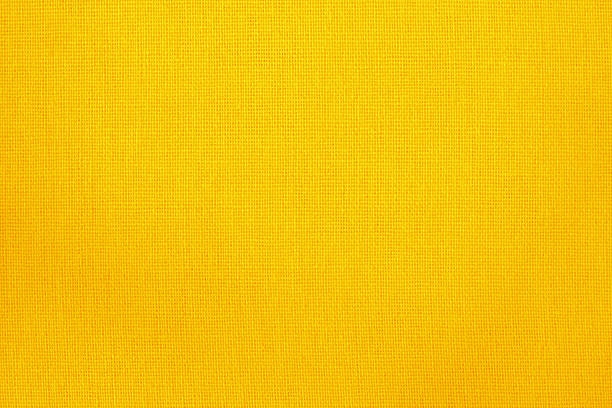 This close-up photograph showcases the intricate texture of a bright yellow mesh fabric, commonly used in sportswear. The macro perspective reveals the pattern of the weave, creating a detailed and visually interesting abstract background perfect for athletic, fashion, or technology-related designs.