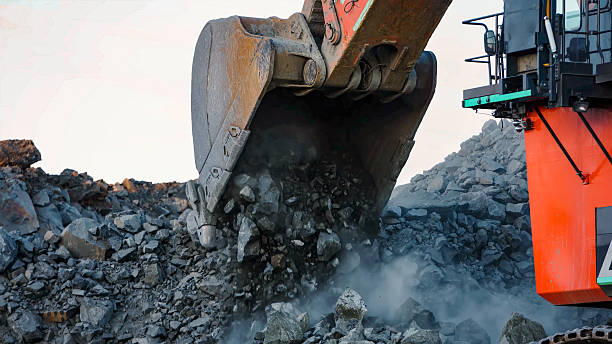 istock Giant mining excavator in the process of extracting rock material in an open pit mine 2248145395