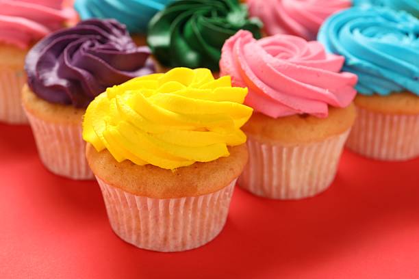 istock Delicious cupcakes with bright cream on red background, closeup 2248145950