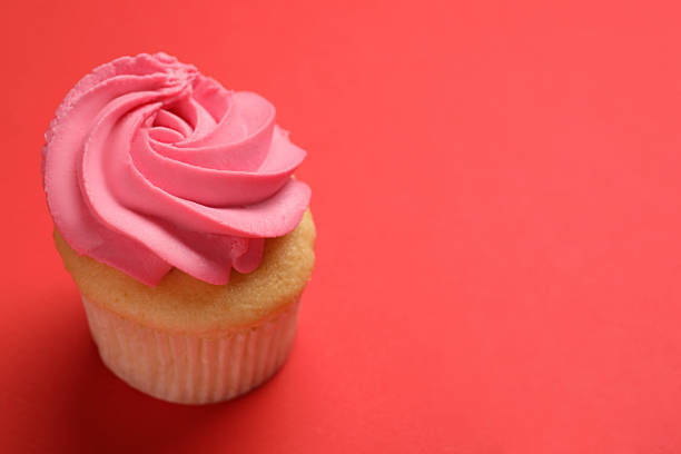 istock Delicious cupcake with bright cream on red background, space for text 2248146042