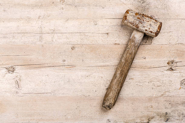 istock old used hammer lying on a wooden workbench 2248148772
