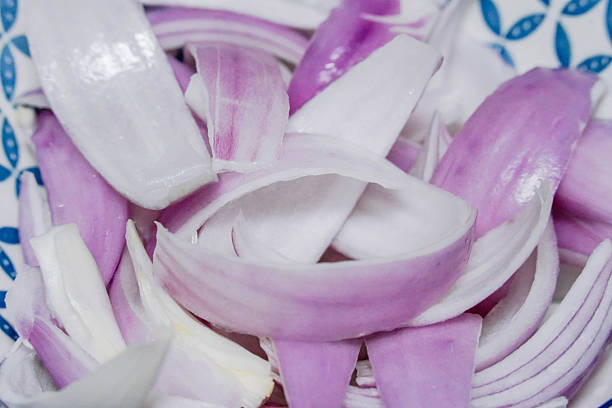 istock Close up of red onion slices in a ceramic bowl in kitchen 2248149454