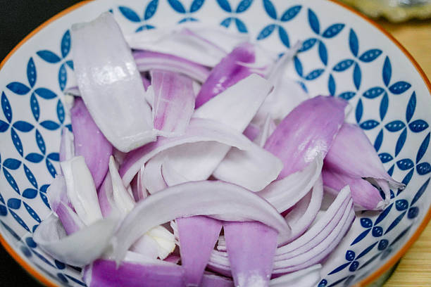 istock Close up of red onion slices in a ceramic bowl in kitchen 2248149455