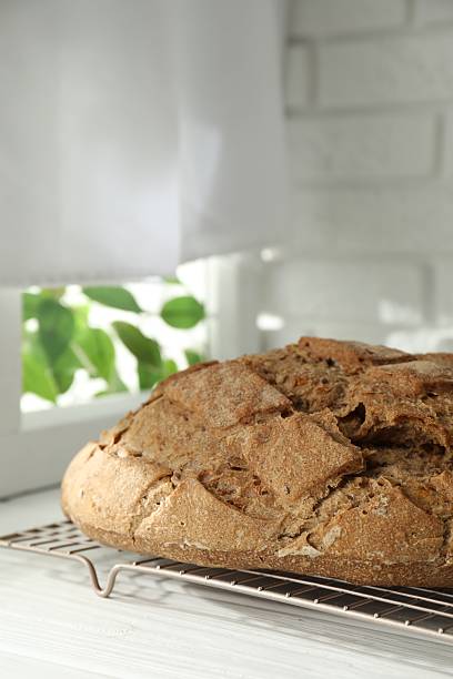 istock Freshly baked sourdough bread on white wooden table indoors 2248150118