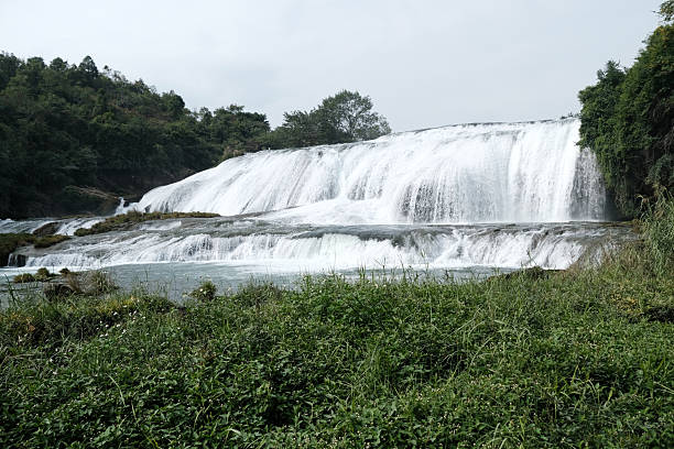 View of the Doupotang Waterfall. It is a 105-meter-wide and 21-meter-high waterfall in Huangguoshu Waterfall Scenic Area, Guizhou, China. The top of the waterfall is the widest among all of the Huangguoshu waterfalls.