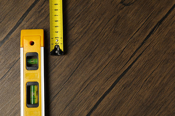 istock Building level and tape measure on wooden table, top view. Space for text 2248151426