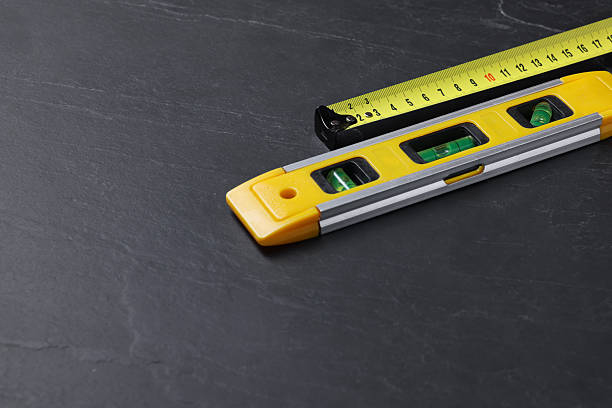 istock Building level and tape measure on black table. Space for text 2248151485