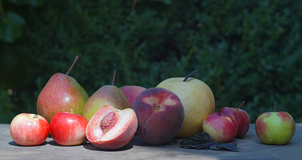 istock Pears, peaches and apples on the board 2248151796