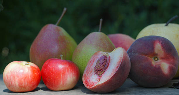 istock Pears, peaches and apples on the board 2248151798