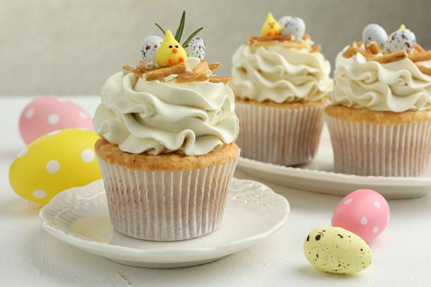 istock Tasty Easter cupcakes with vanilla cream on white table, closeup 2248152522