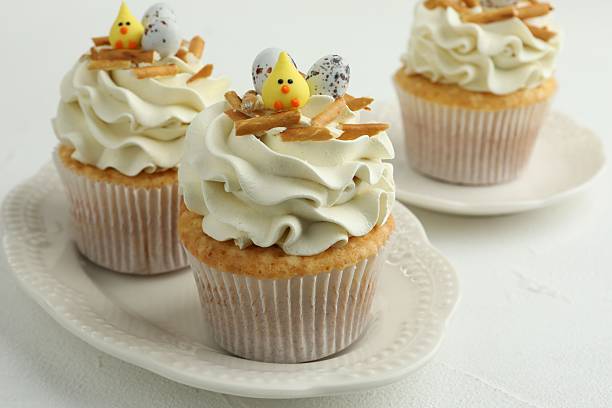 istock Tasty Easter cupcakes with vanilla cream on white table, closeup 2248152524
