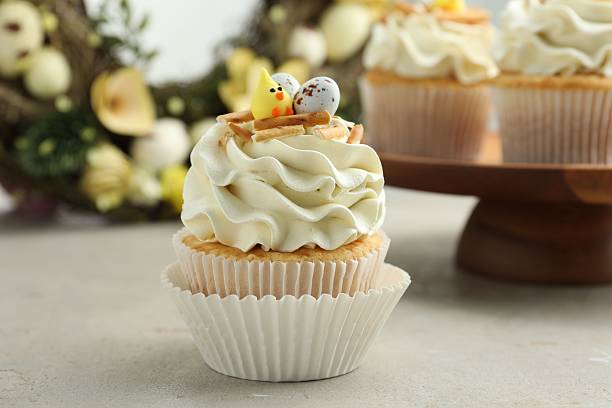 istock Tasty Easter cupcakes with vanilla cream on gray table 2248152554