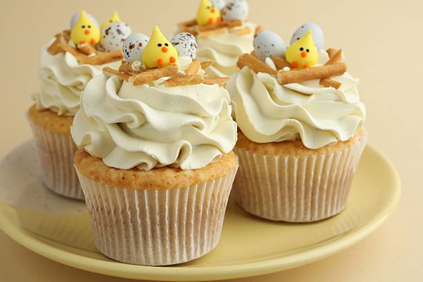 istock Tasty Easter cupcakes with vanilla cream on beige background, closeup 2248152577