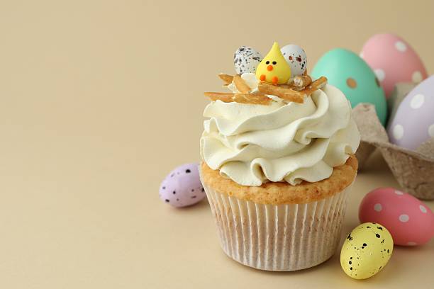 istock Tasty Easter cupcake with vanilla cream and candies on beige background, space for text 2248152579