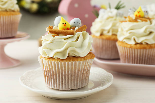istock Tasty Easter cupcakes with vanilla cream on light wooden table 2248152611
