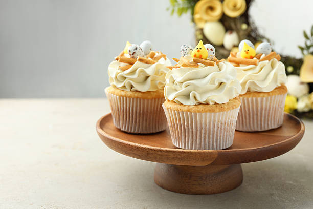 istock Tasty Easter cupcakes with vanilla cream on gray table, space for text 2248152670