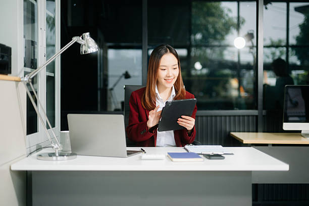 istock Asian businesswoman working in the office with working notepad, tablet and laptop documents 2248153806