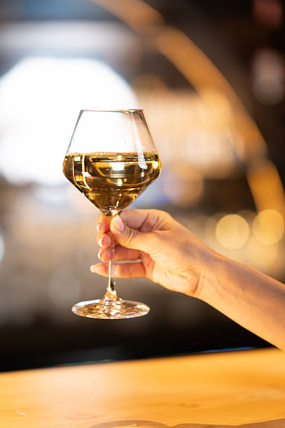 istock Hand holding a glass of white wine 2248153971