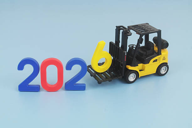 istock Yellow forklift truck arranging numbers 2026 on blue background. 2248155247