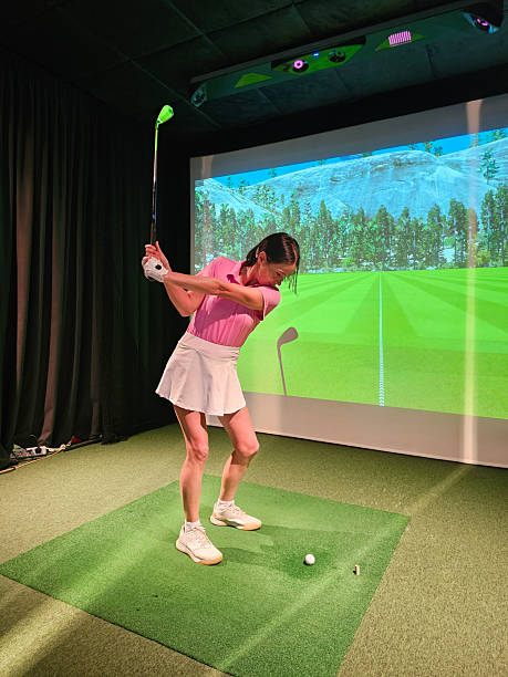 istock Woman practicing her golf swing indoors at a virtual golf simulator 2248155506