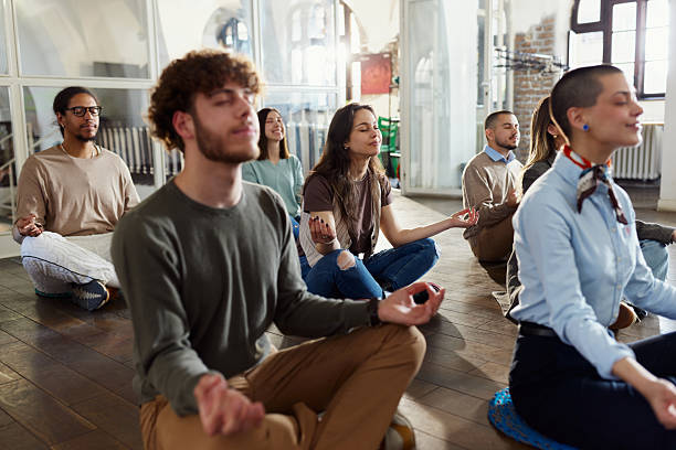 istock Creative people meditating at casual office. 2248155554