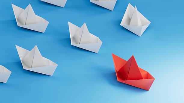 istock concept 3D paper ship on opposite direction with isolated blue background.3D rendering on blue background. 2248156228