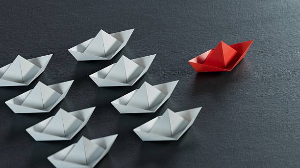 Different business concept.new ideas. paper art style. creative idea.Leadership concept, black leader boat leading white boats.3D rendering on black background.
