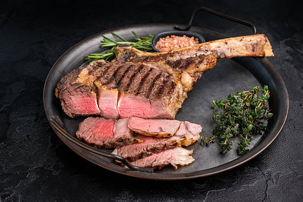 istock Roasted Tomahawk beef steak, roast dry aged rib eye with bone. black background. top view 2248156790