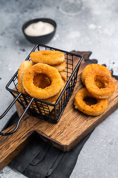 istock Deep Fried crunchy onion rings, delicious snack. grey background. top view 2248156855