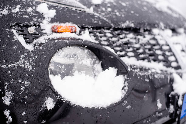 Turned off headlight covered with fresh snow