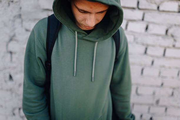 istock Young man standing alone reflecting on urban street 2248157833