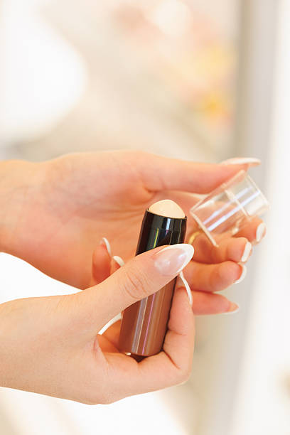 istock Female hands opening primer in the make-up section 2248158413