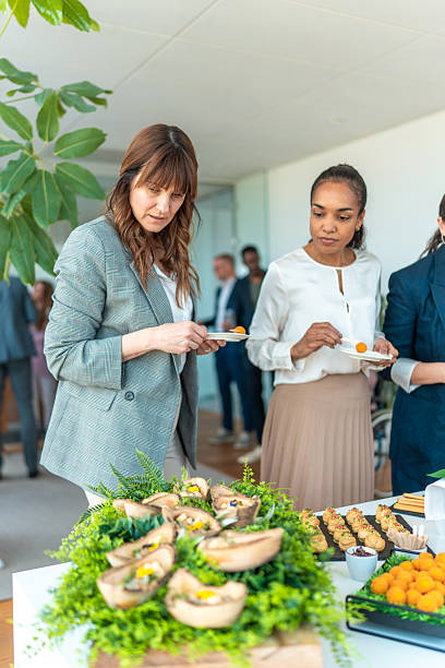 istock Business Professionals Enjoying Appetizers at Corporate Event Buffet 2248160475
