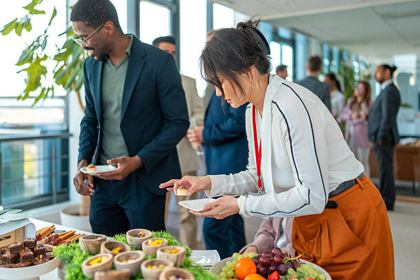 istock Diverse Group of Professionals Selecting Food at Office Buffet 2248160485