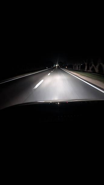 istock dark rural drive, silent highway under night sky, desolate rural road bathed in vehicle illumination 2248160570