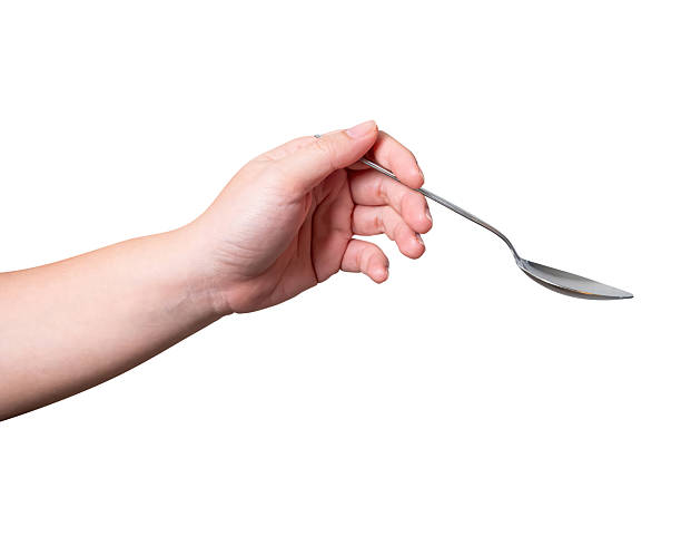 istock Female hand holding a black plastic spoon isolated on white background. 2248164454