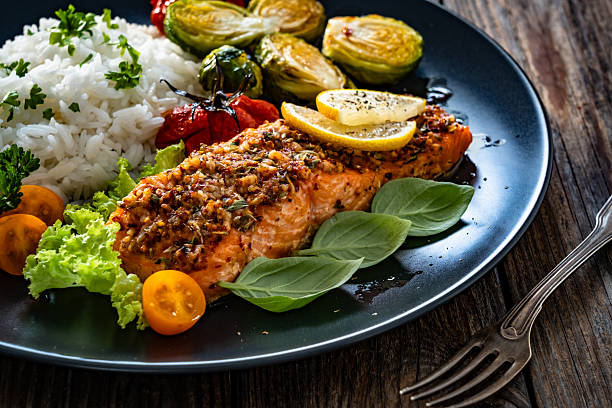 istock Baked salmon with white rice on wooden table 2248164510