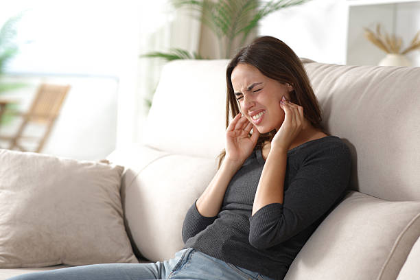 istock Stressed woman suffering jaw ache and complaining at home 2248164803