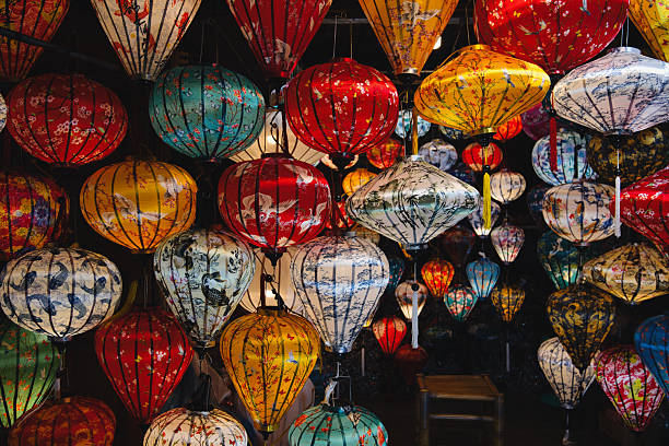 istock Vibrant silk lanterns with ornate patterns hang above a bustling hoi an night market, glowing warmly and casting festive light over stalls and colorful decorations 2248164804