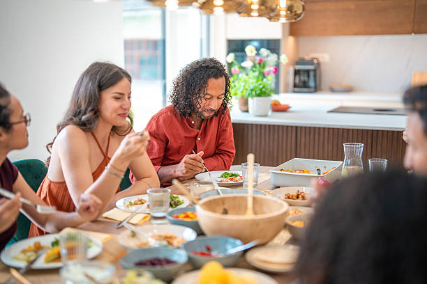 istock Diverse Friends Enjoying a Gourmet Dinner in a Modern Indoor Setting with Warm Lighting 2248165076