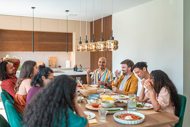 istock Multiethnic Friends Share Modern Dining Experience Under Pendant Lights In Contemporary Home 2248165083