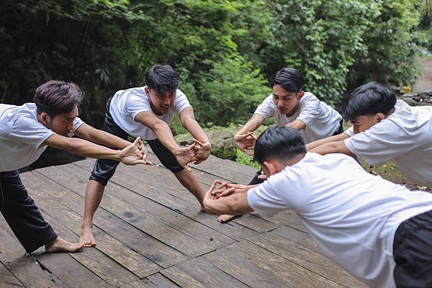 Indonesian Male Dancers Warming Up Together in a Circle at Nature